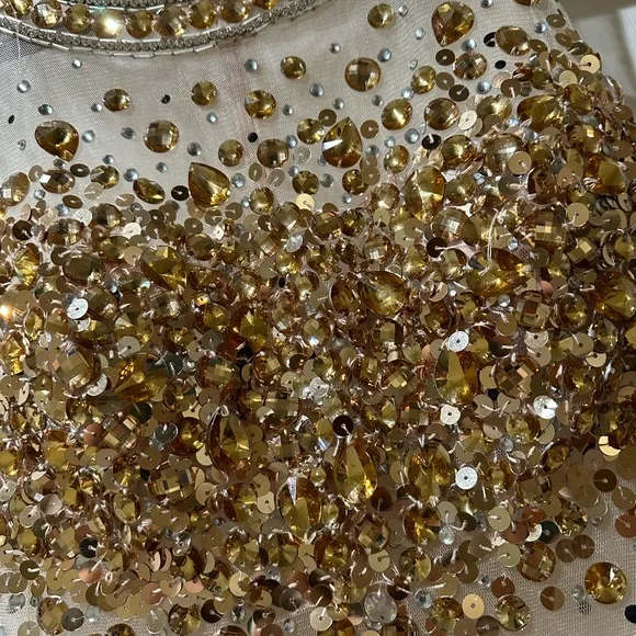 JOVANI mini illusion dress. With sheer material and gold stones. Size 2